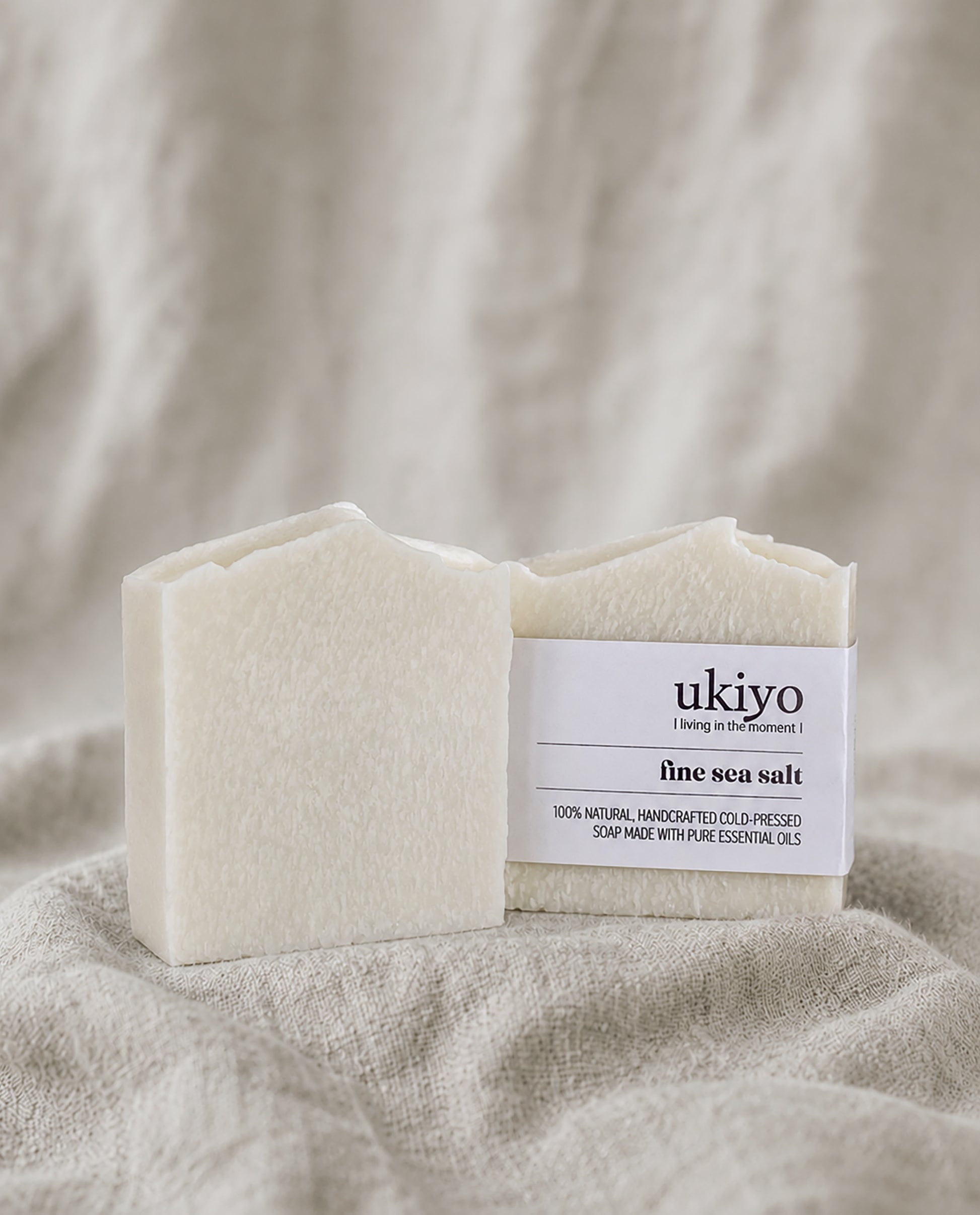 Bar of sea salt soap with a 'ukiyo' label on a textured beige background